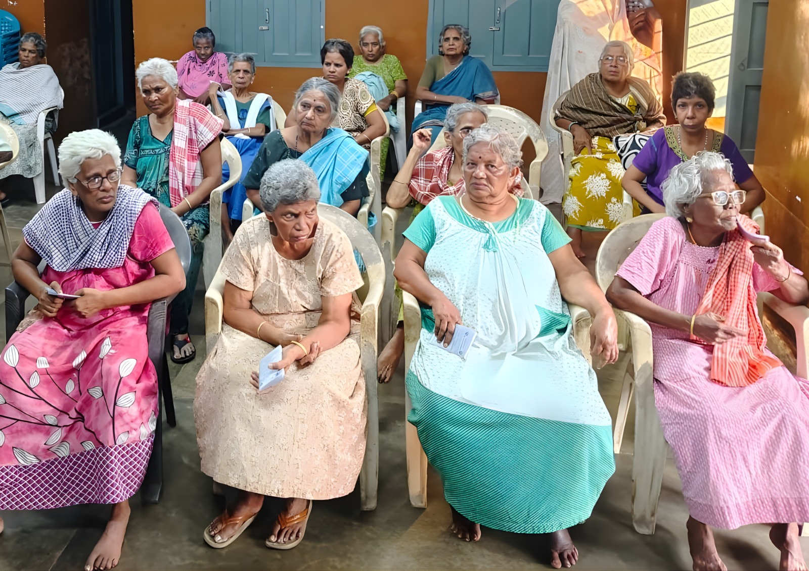 Volunteers distributing supplies to elderly community members.
